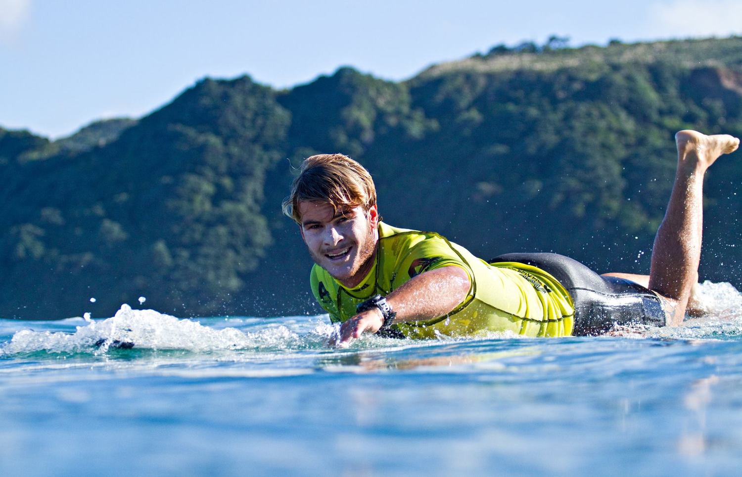 Zane Kekoa Schweitzer paddling on his board in Maui